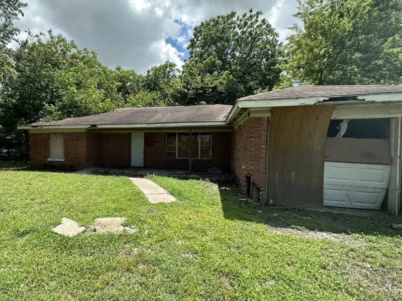 Abandoned home in Baytown, TX purchased by Volcan Property Buyers in as-is condition despite extensive repair needs.