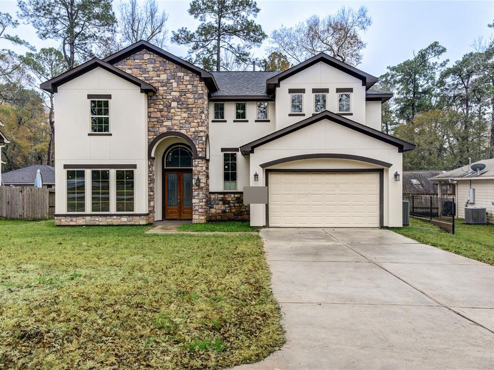 Front exterior of a rebuilt two-story home in Panorama, Conroe TX freed from foreclosure and liens