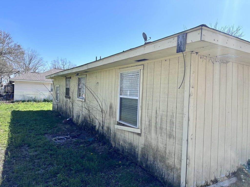 Side view of as-is home bought for cash in Sunrise Courts, Baytown TX