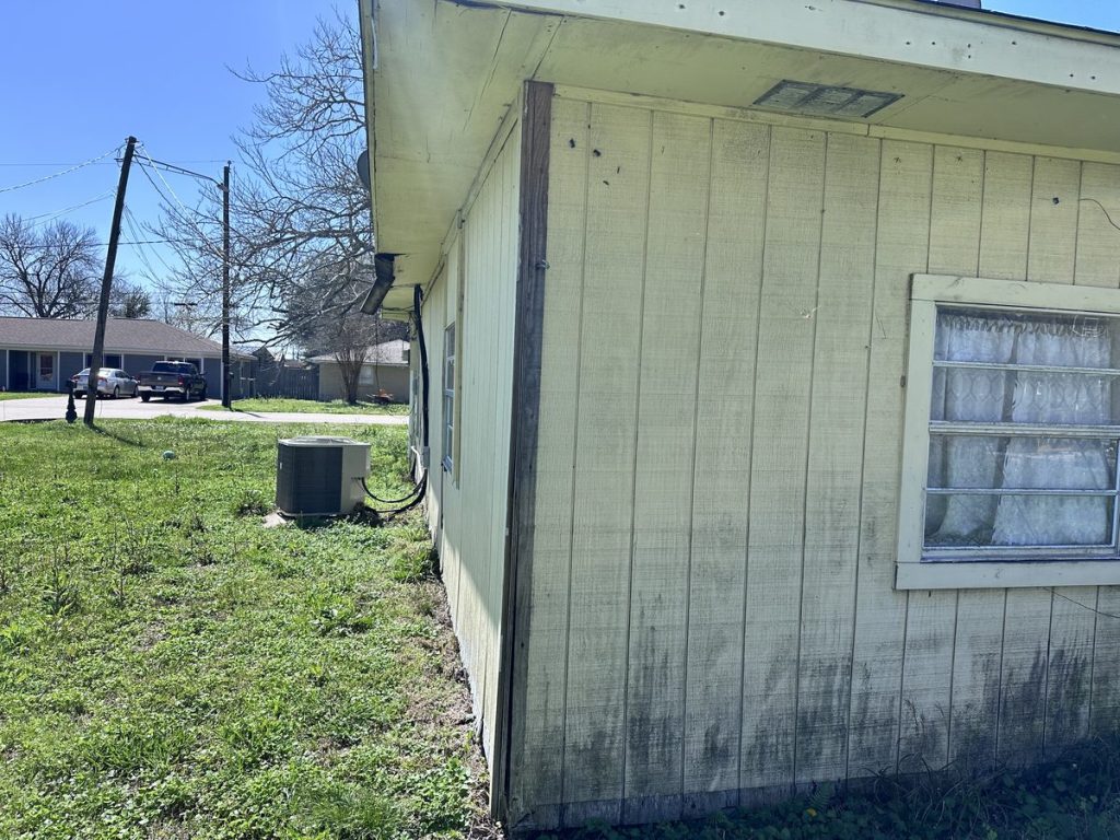 Corner view of inherited property purchased as-is in Sunrise Courts, Baytown TX