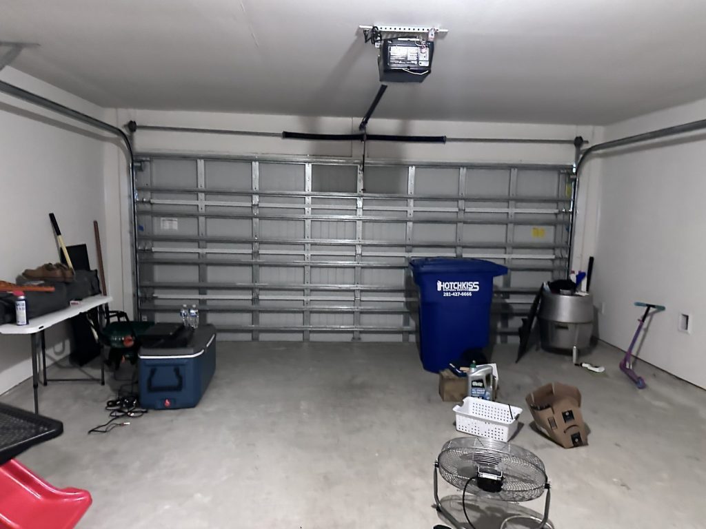 Garage of as-is home bought for cash in Mont Belvieu, TX