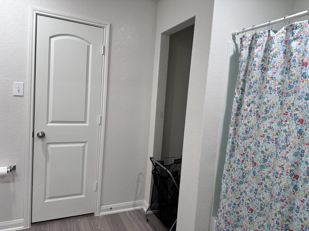 Hallway and bathroom of Mont Belvieu, TX home sold as-is for cash