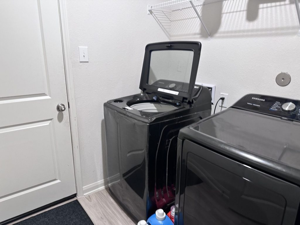 Laundry room of as-is home bought for cash in Mont Belvieu, TX