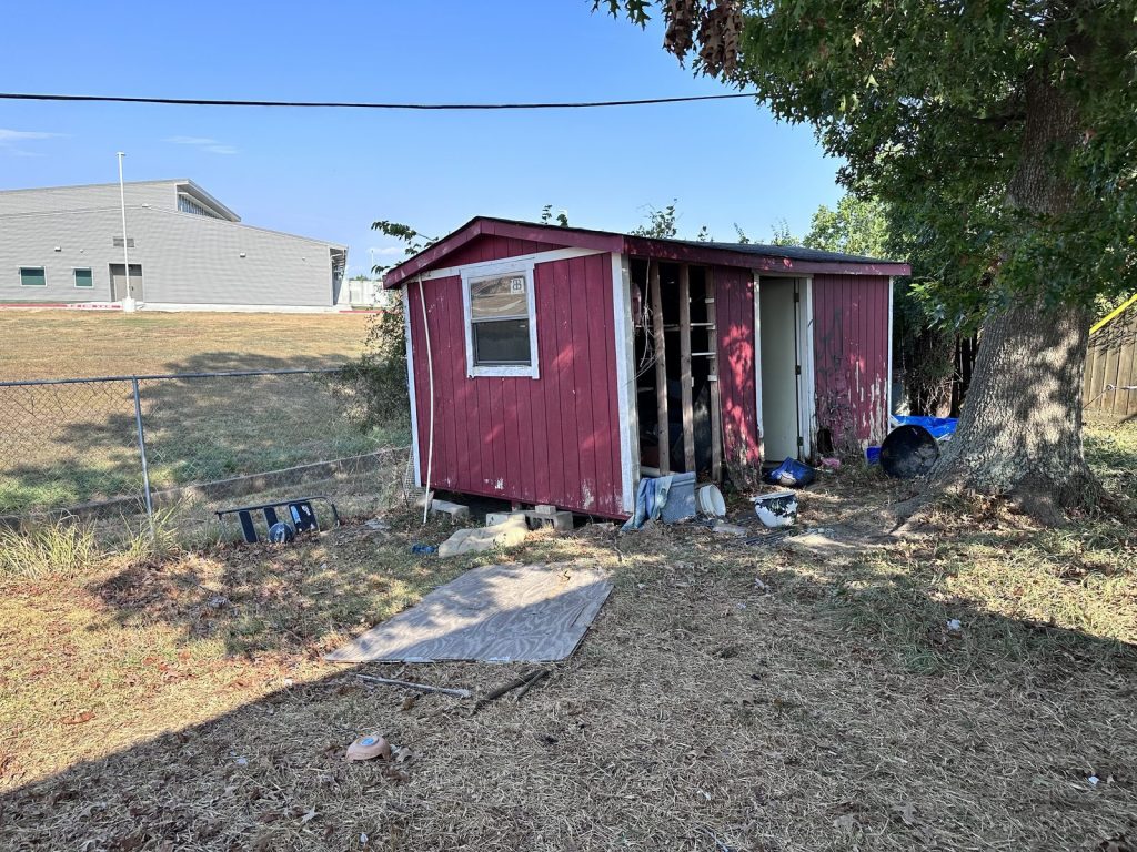Deteriorating backyard shed of poorly maintained inherited home in Glen Arbor, Baytown TX