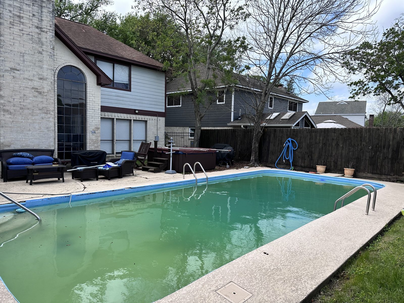 Backyard pool of inherited two-story home bought for cash as-is before foreclosure in Baytown TX