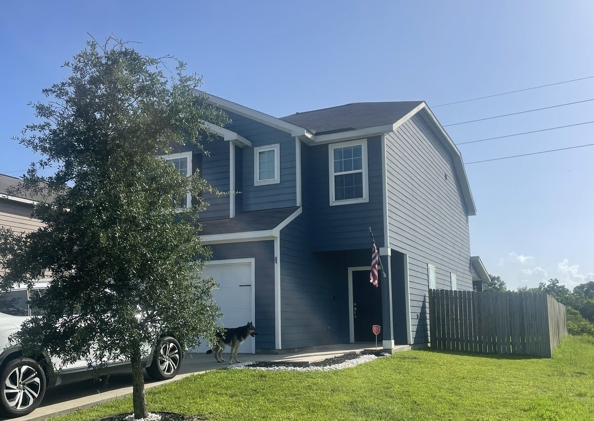 Front exterior of two-story home on Crustacean Rd bought for cash as-is in Mont Belvieu, TX