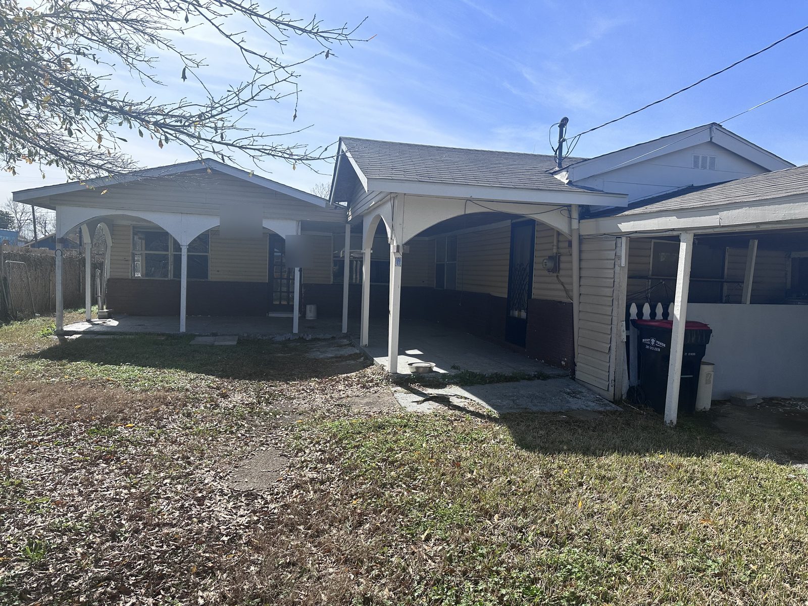 Front exterior of vacant vandalized home bought for cash as-is in Goose Creek, Baytown TX