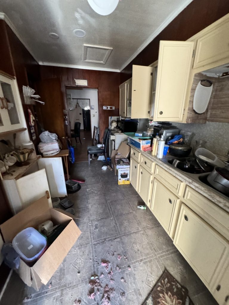 Kitchen before cleanout in as-is Baytown TX home bought for cash