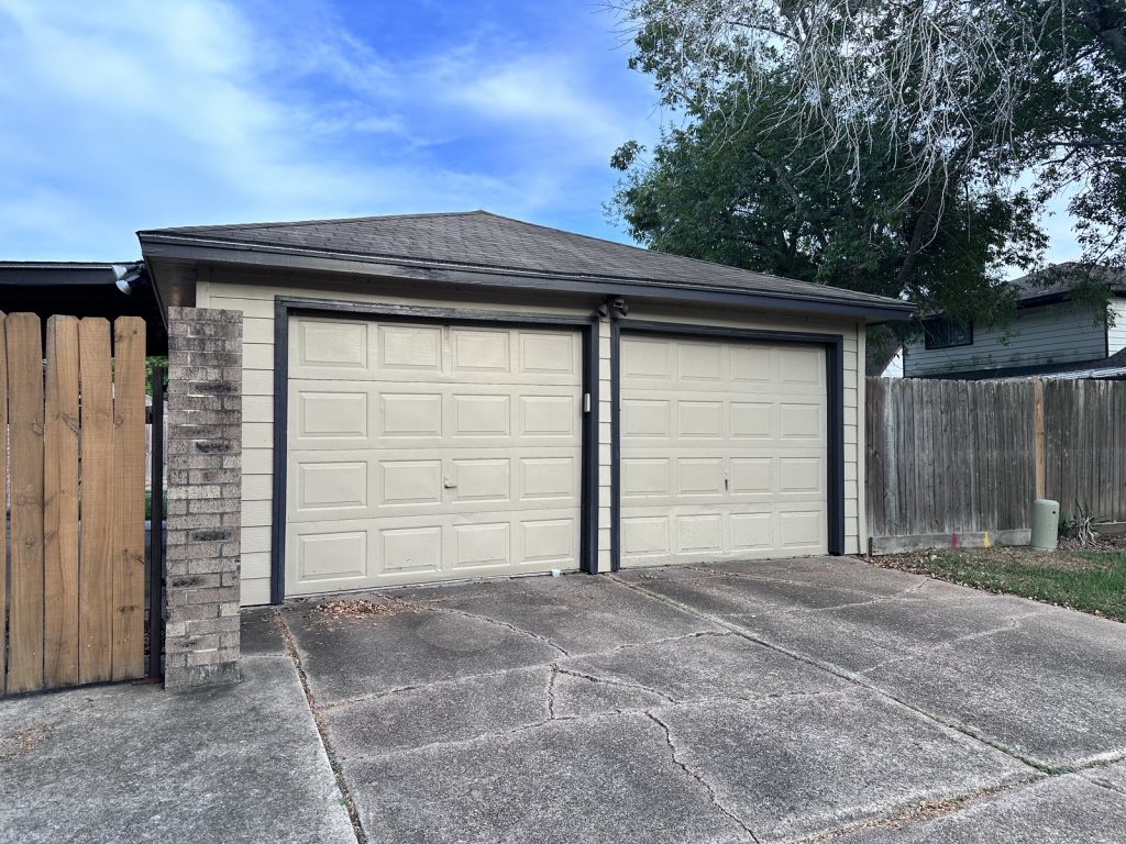 Detached garage with cracked driveway at a Frostview Lane home in Missouri City, TX