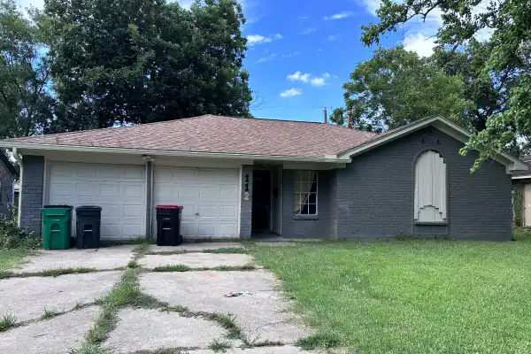Front exterior of inherited Houston property sold as-is with major repairs needed