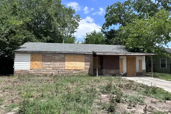 Front exterior of abandoned Lake Park Drive property requiring extensive repairs before sale