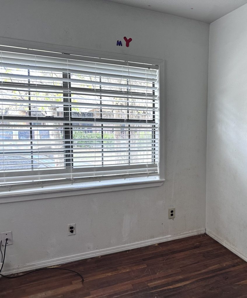 Empty room with settling floor in as-is Middletown, Baytown TX home bought for cash