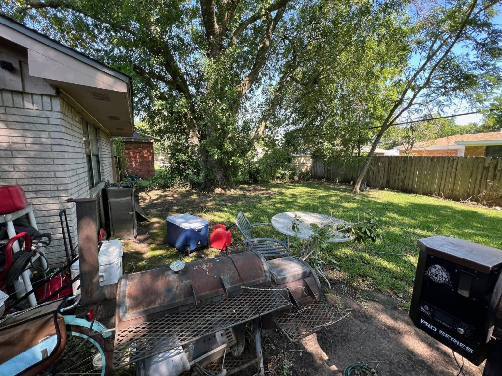 Fenced back garden with mature pecan at as-is rental home bought in Texas City TX