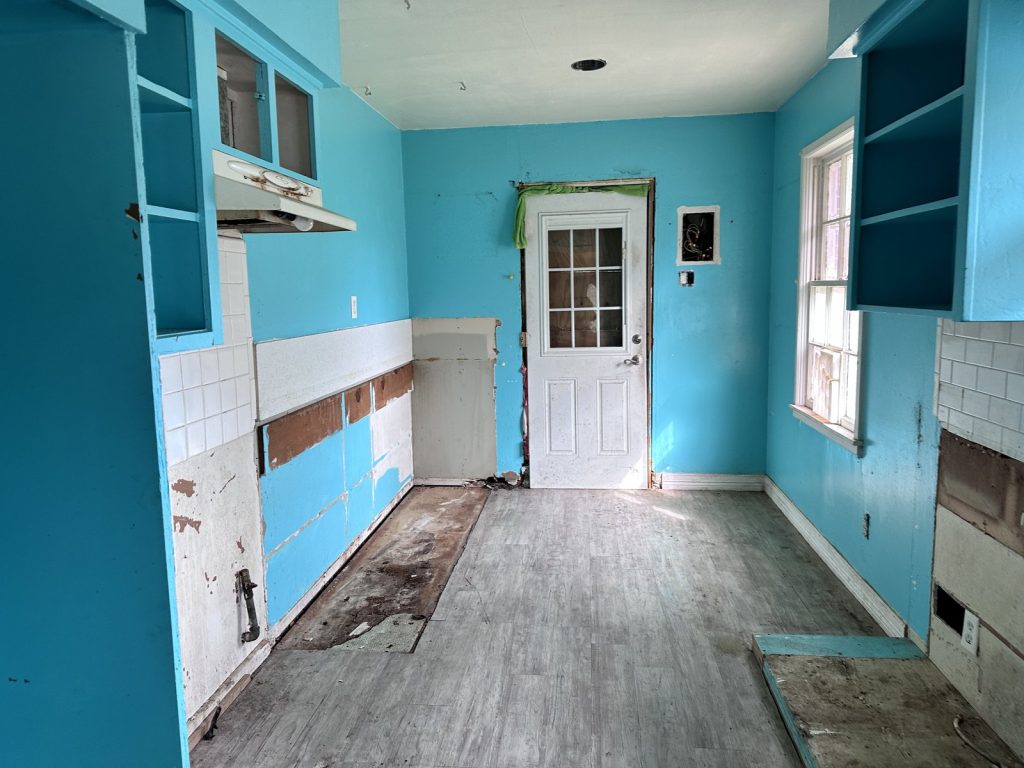 Kitchen stripped back to bare walls in as-is home purchased in La Marque TX
