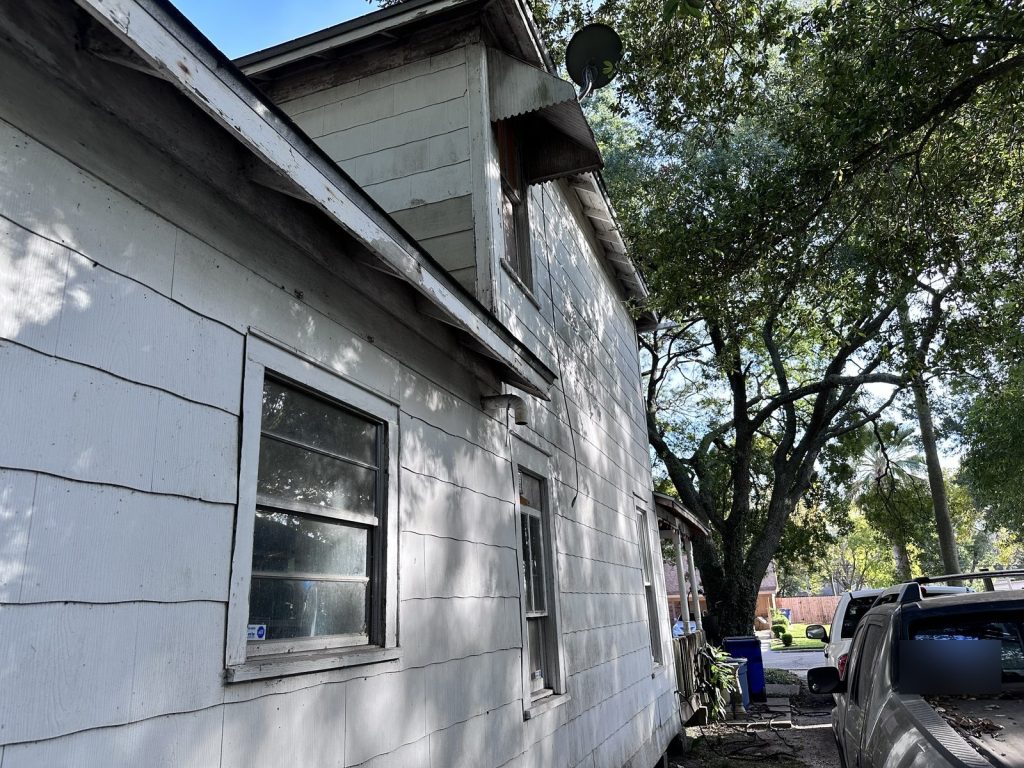 Weathered clapboard siding on as-is home purchased in North Texas City, Texas City TX