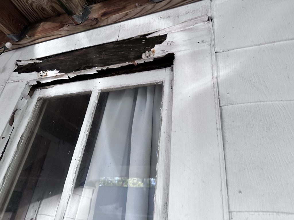 Rotted window trim on century-old home bought as-is in Texas City TX