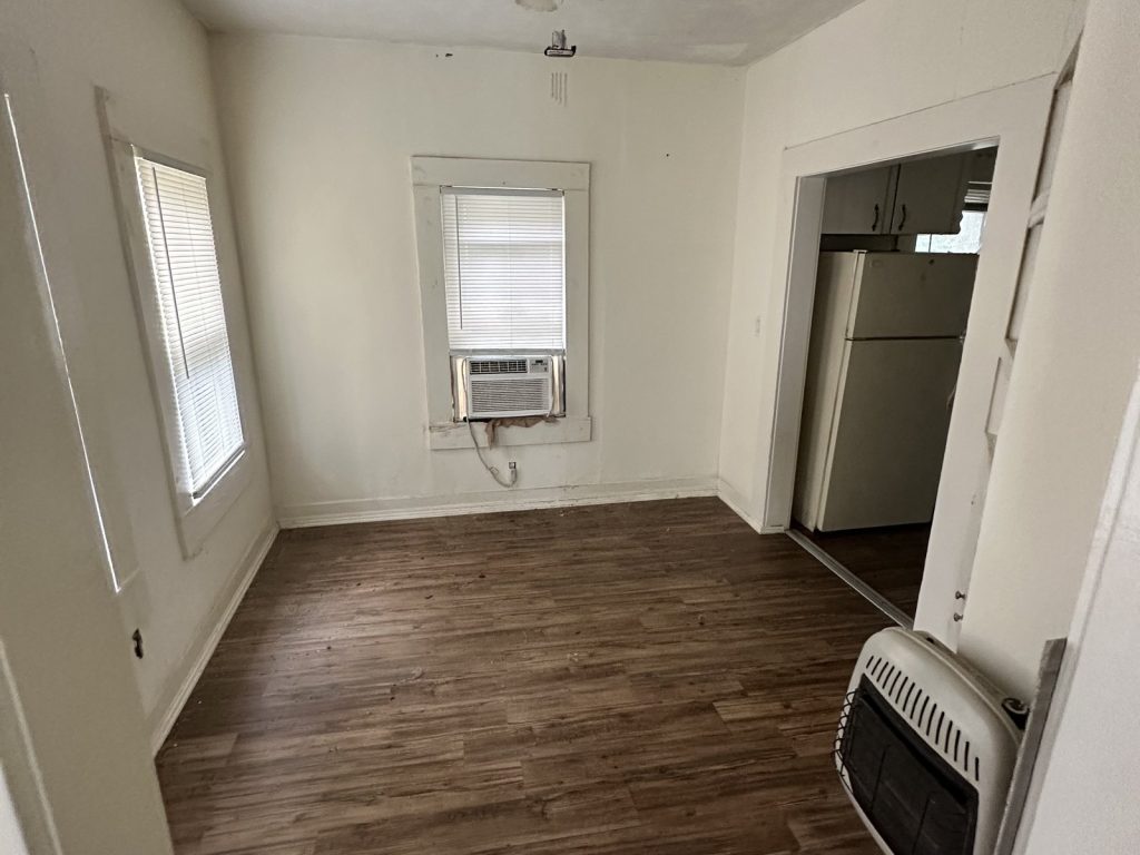 Empty room with window air unit in vacant as-is home purchased in La Marque TX