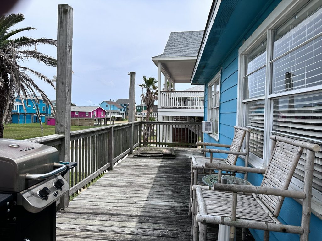 Timber deck and stilt-house outlook at as-is beach home purchased in Treasure Island, Freeport TX