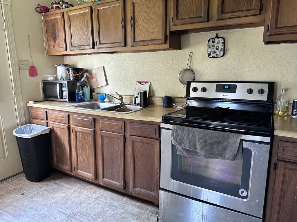 Original timber kitchen cabinetry in as-is home purchased for cash in Freeport TX