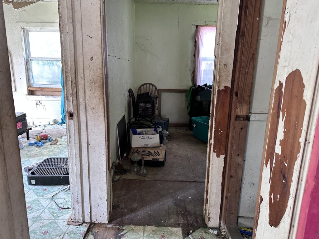Debris-strewn hallway in vacant as-is home purchased in La Marque TX