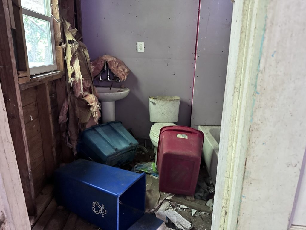 Gutted bathroom in vacant as-is home bought for cash in La Marque TX