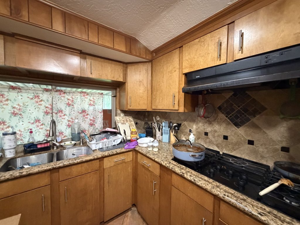 Dated original kitchen inside tired landlord's rental sold for cash in South Park, Houston TX
