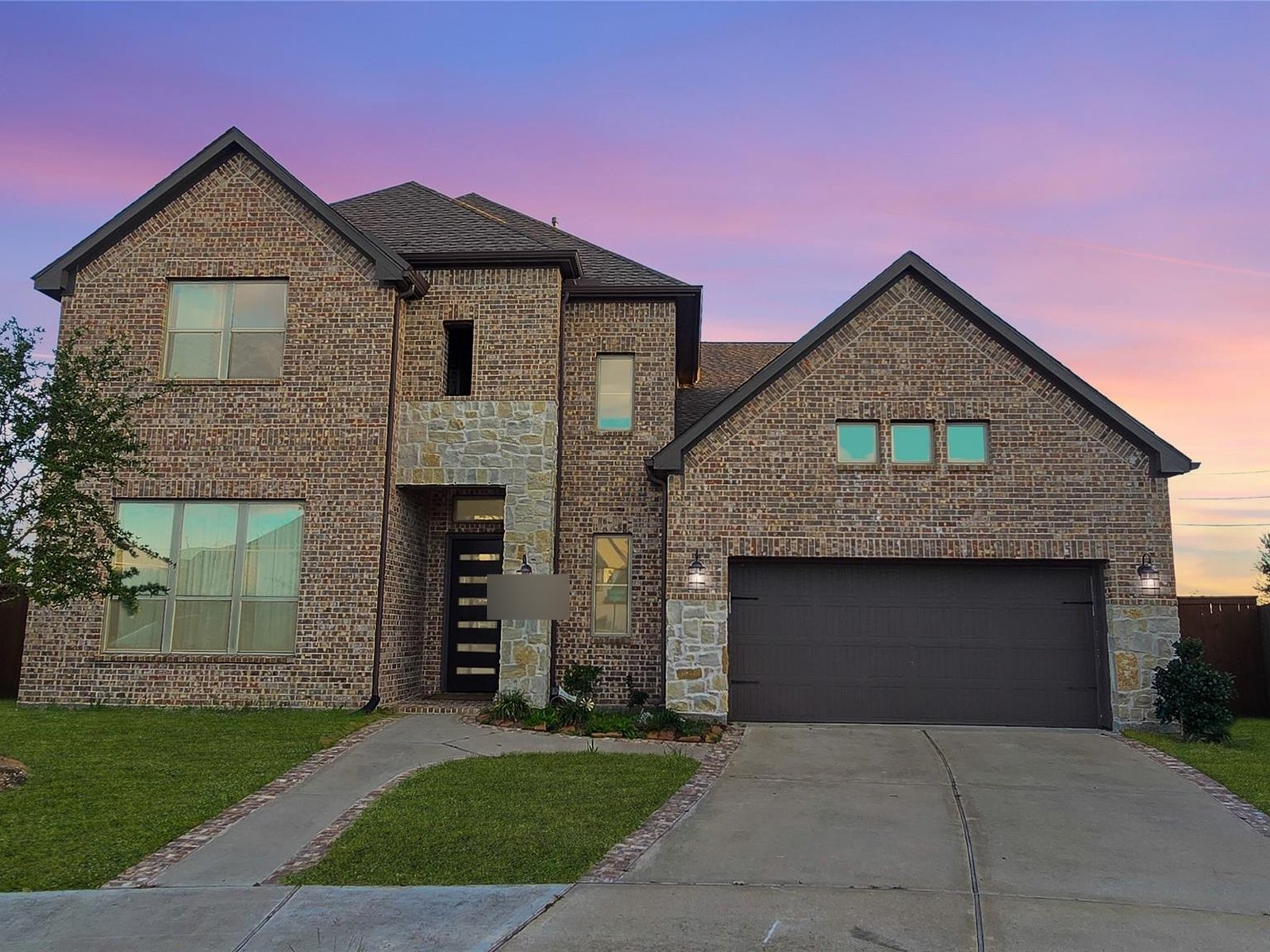 Front exterior of a newer two-story home in Elyson, Katy TX bought for cash before foreclosure