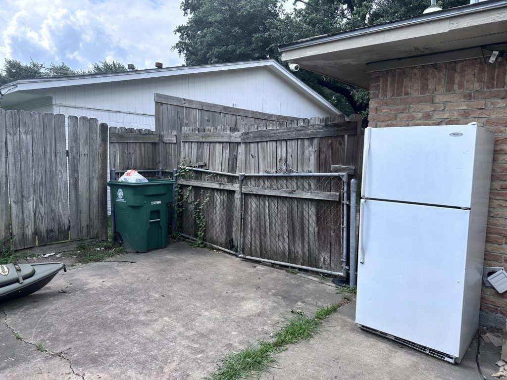 Backyard exterior of a distressed home in Oak Forest, Houston TX bought for cash before foreclosure