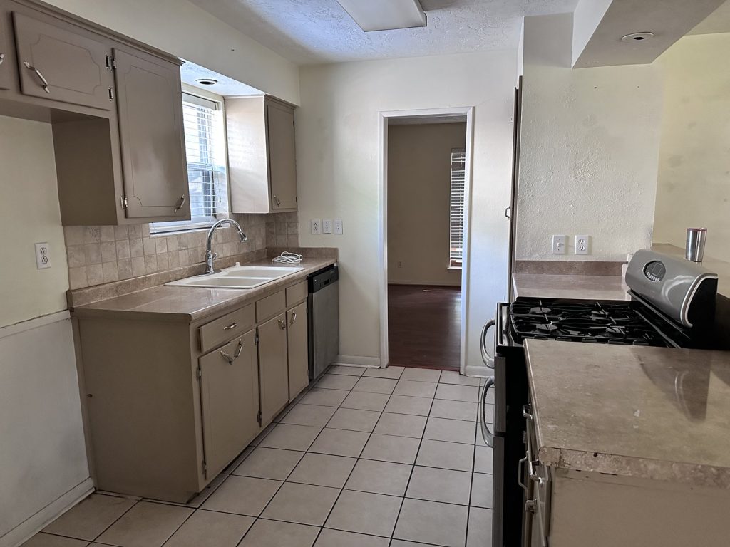 Kitchen inside a distressed Oak Forest, Houston home sold as-is for cash
