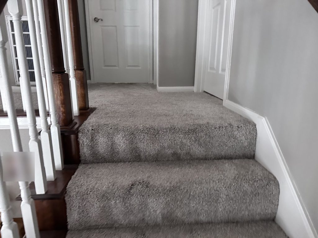 Carpeted stairway in well-kept Briar Forest Houston TX townhouse purchased as-is