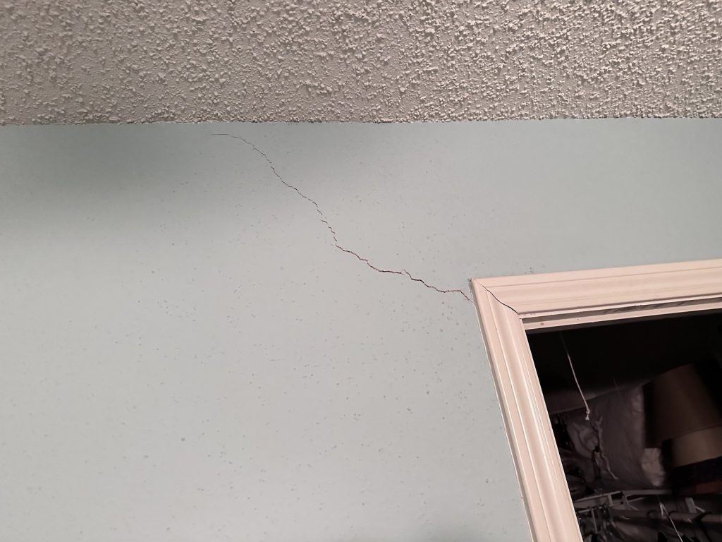 Settlement crack above a doorframe in west Houston TX townhouse bought for cash