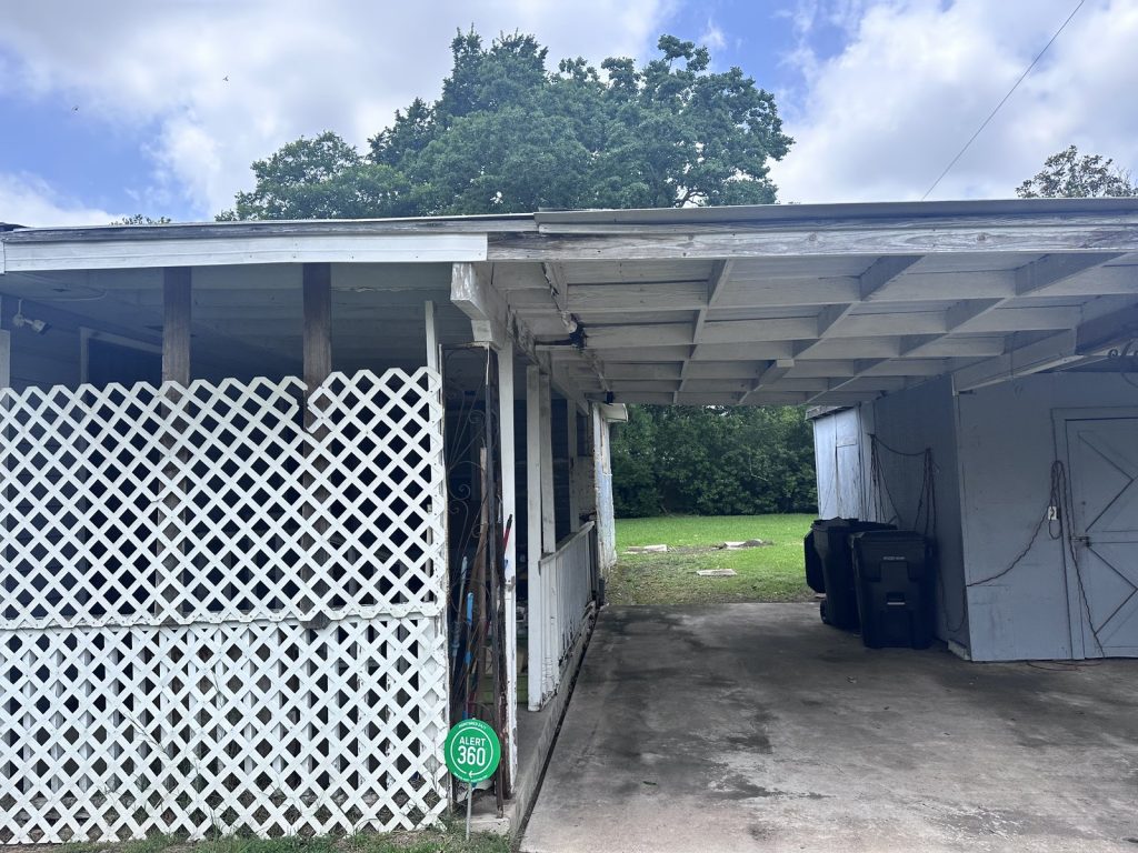 Aging carport of distressed home purchased as-is in Clearview Manor, Houston TX