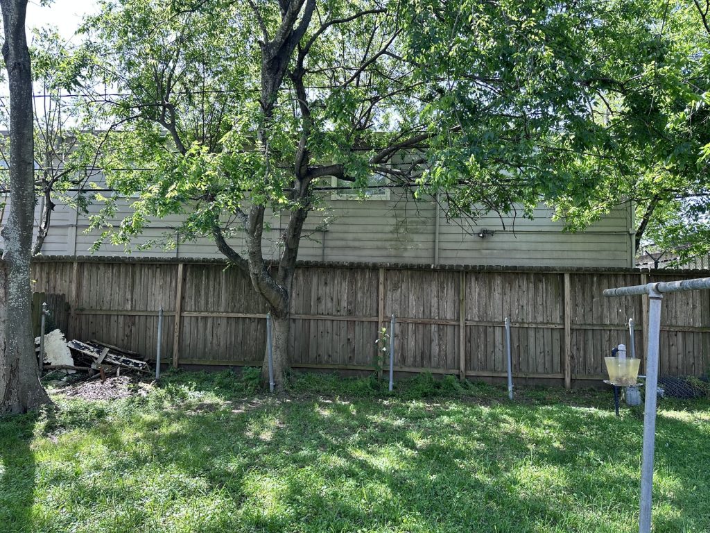 Backyard exterior of a distressed fixer-upper in Oak Forest, Houston TX bought for cash