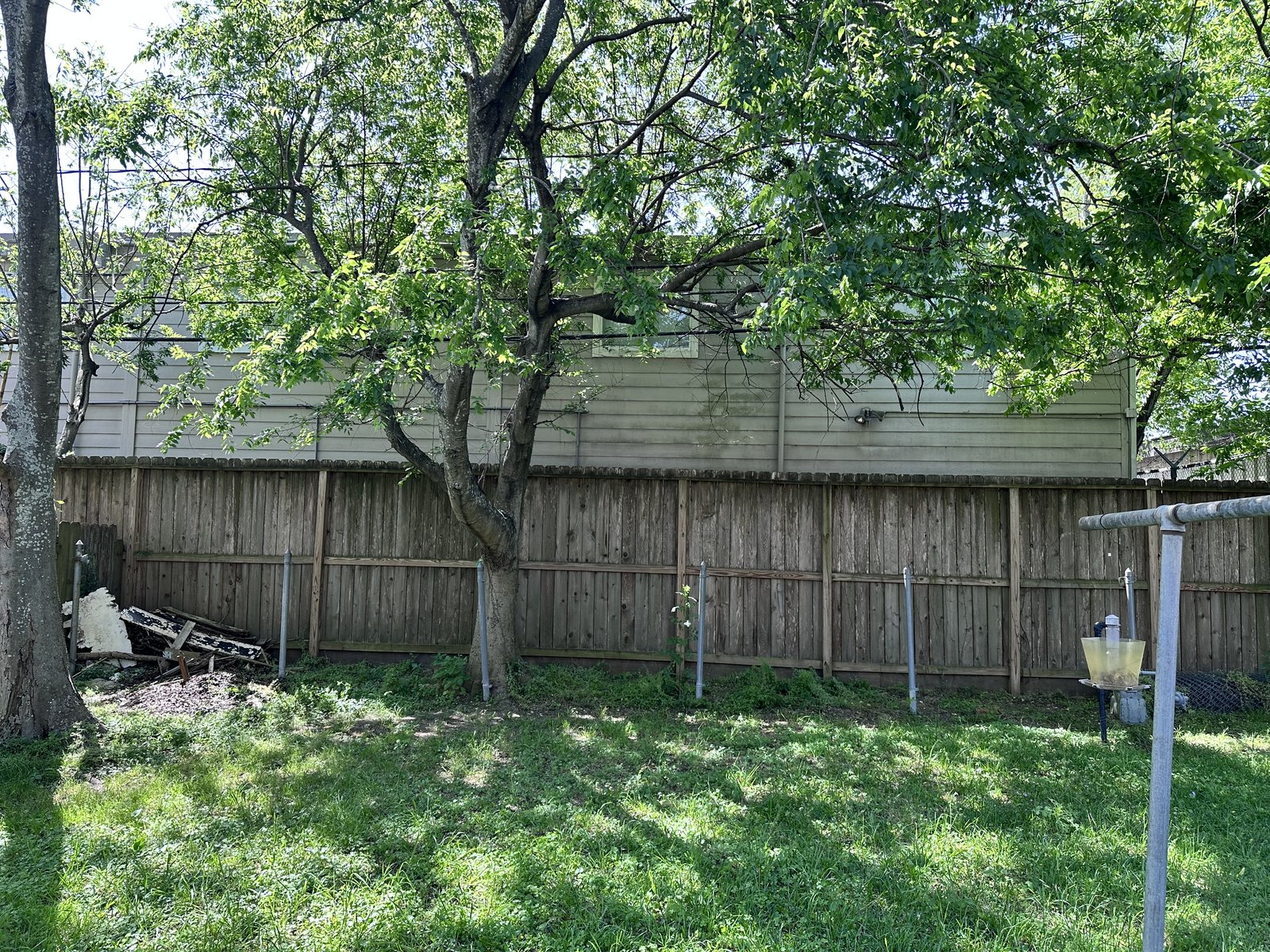 Backyard exterior of a distressed fixer-upper in Oak Forest, Houston TX bought for cash