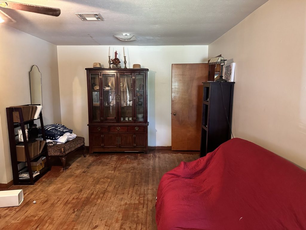 Worn interior room inside a distressed Oak Forest, Houston home sold as-is