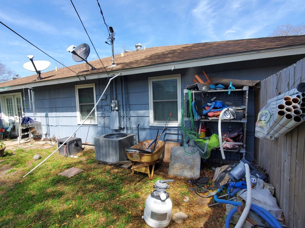 Rear exterior showing deferred maintenance on Houston TX home sold for cash