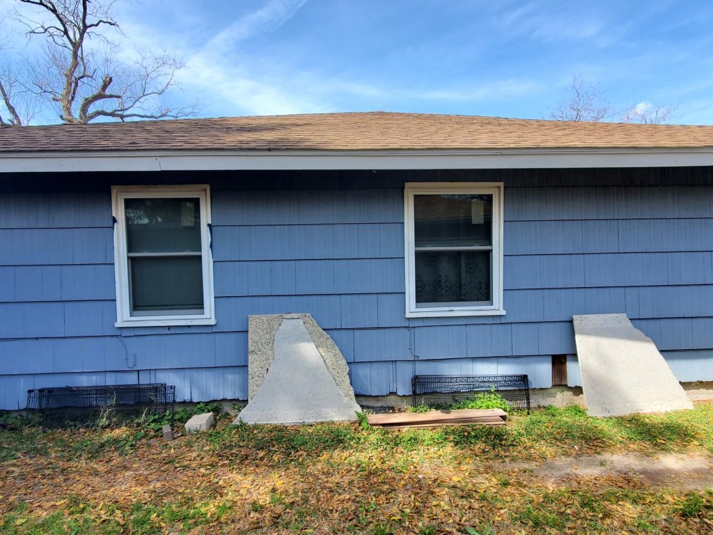 Weathered shingle siding on home purchased as-is in Eastridge Terrace, Houston TX