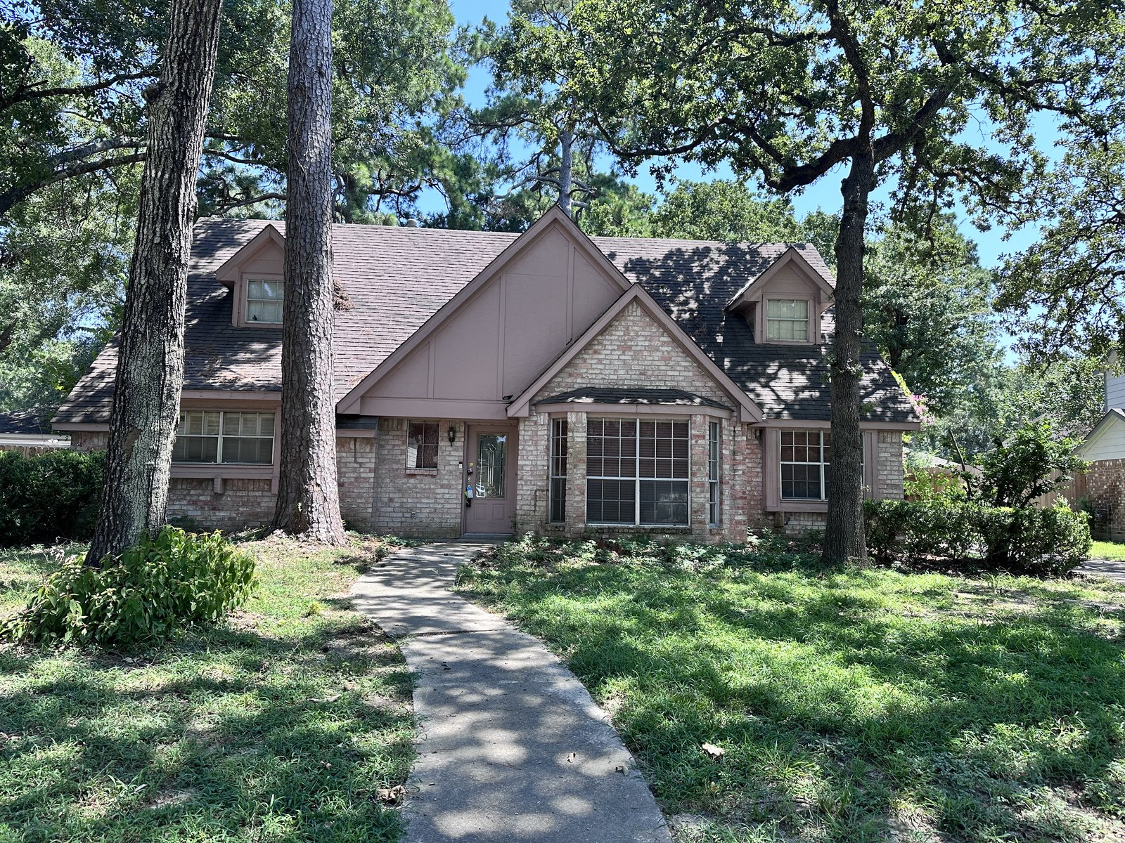 Front exterior of a two-story home in Ravensway, Cypress TX bought for cash