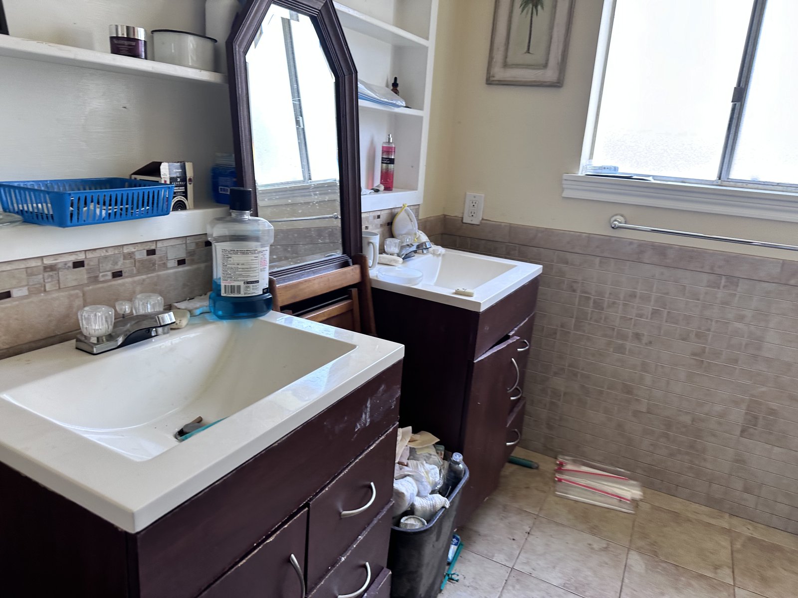Cluttered bathroom in an inherited Nassau Bay home with structural issues