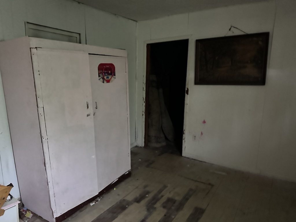 Bedroom and hallway inside a vacant Kashmere Gardens, Houston home sold for cash