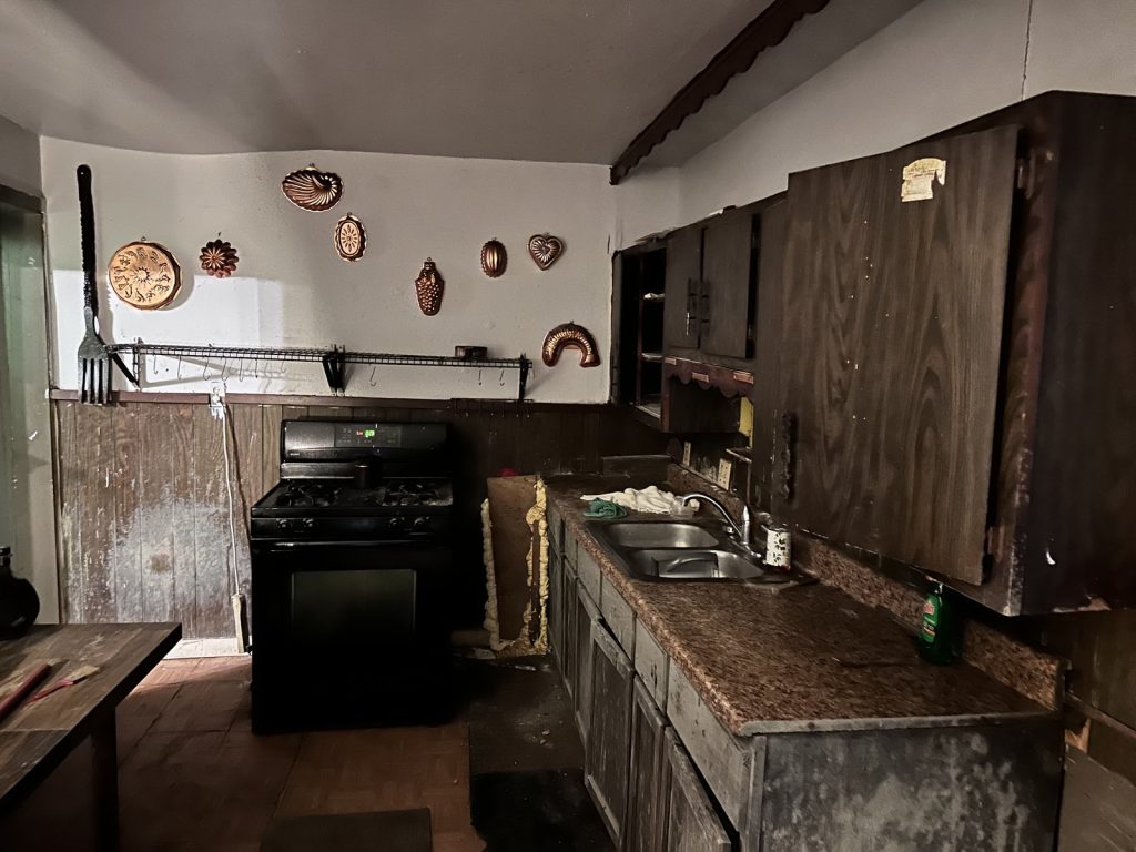 Dated kitchen inside an abandoned estate home in Kashmere Gardens, Houston TX purchased as-is