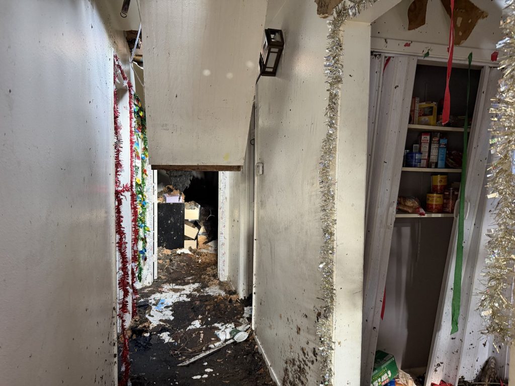 Fire-damaged hallway and pantry inside a Northeast Houston property bought for cash