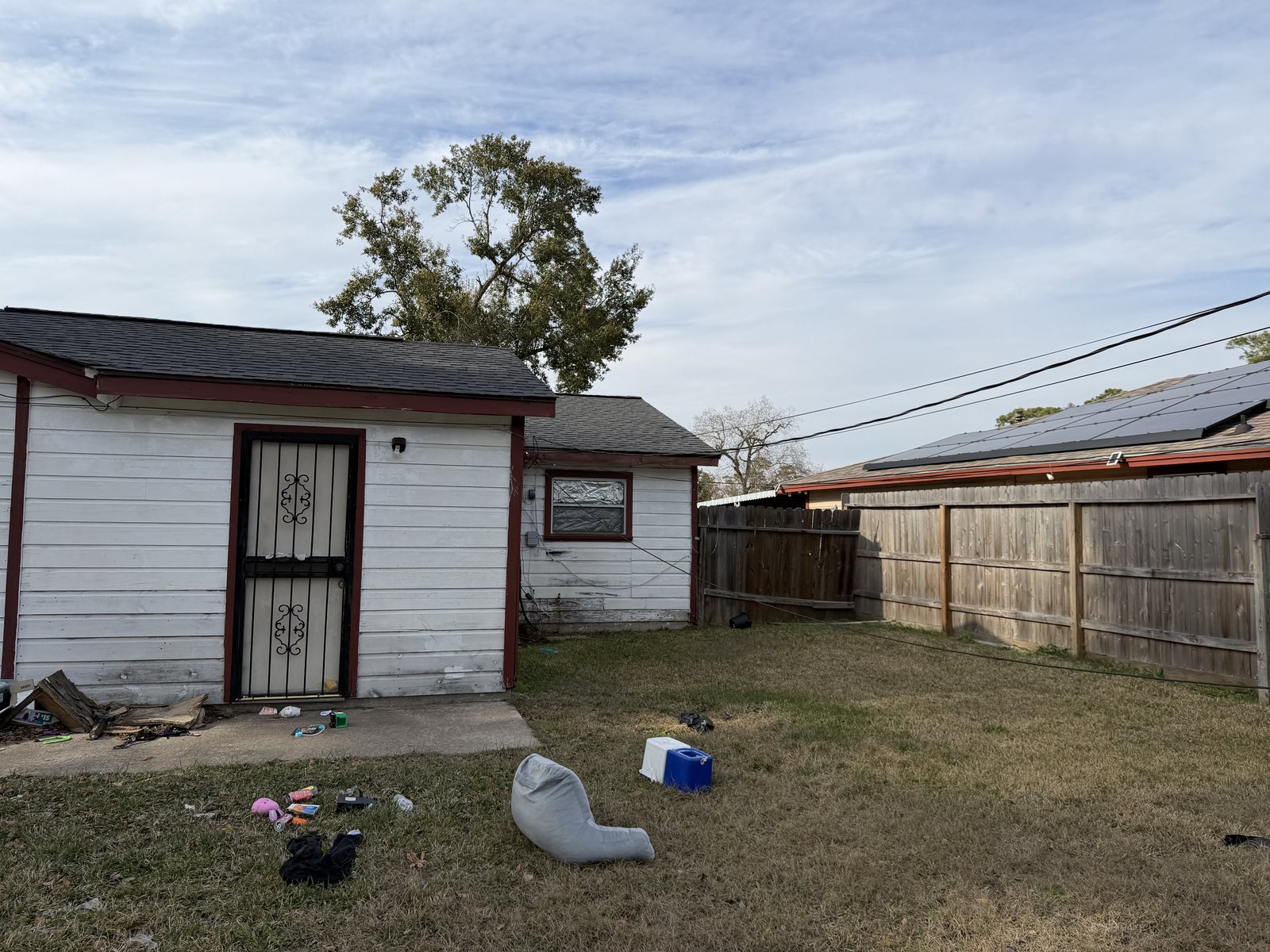 Rear exterior of a fire-damaged home near Wayside in Northeast Houston, TX bought as-is for cash