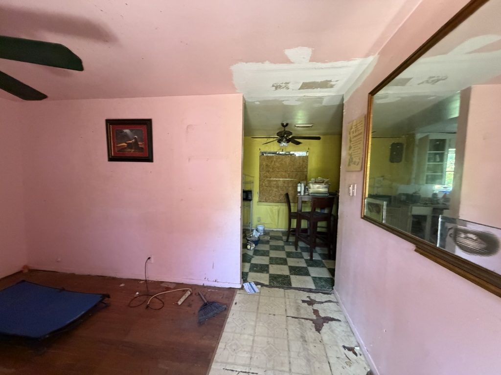 Living and dining area inside an inherited Northwood Manor, Houston home sold as-is