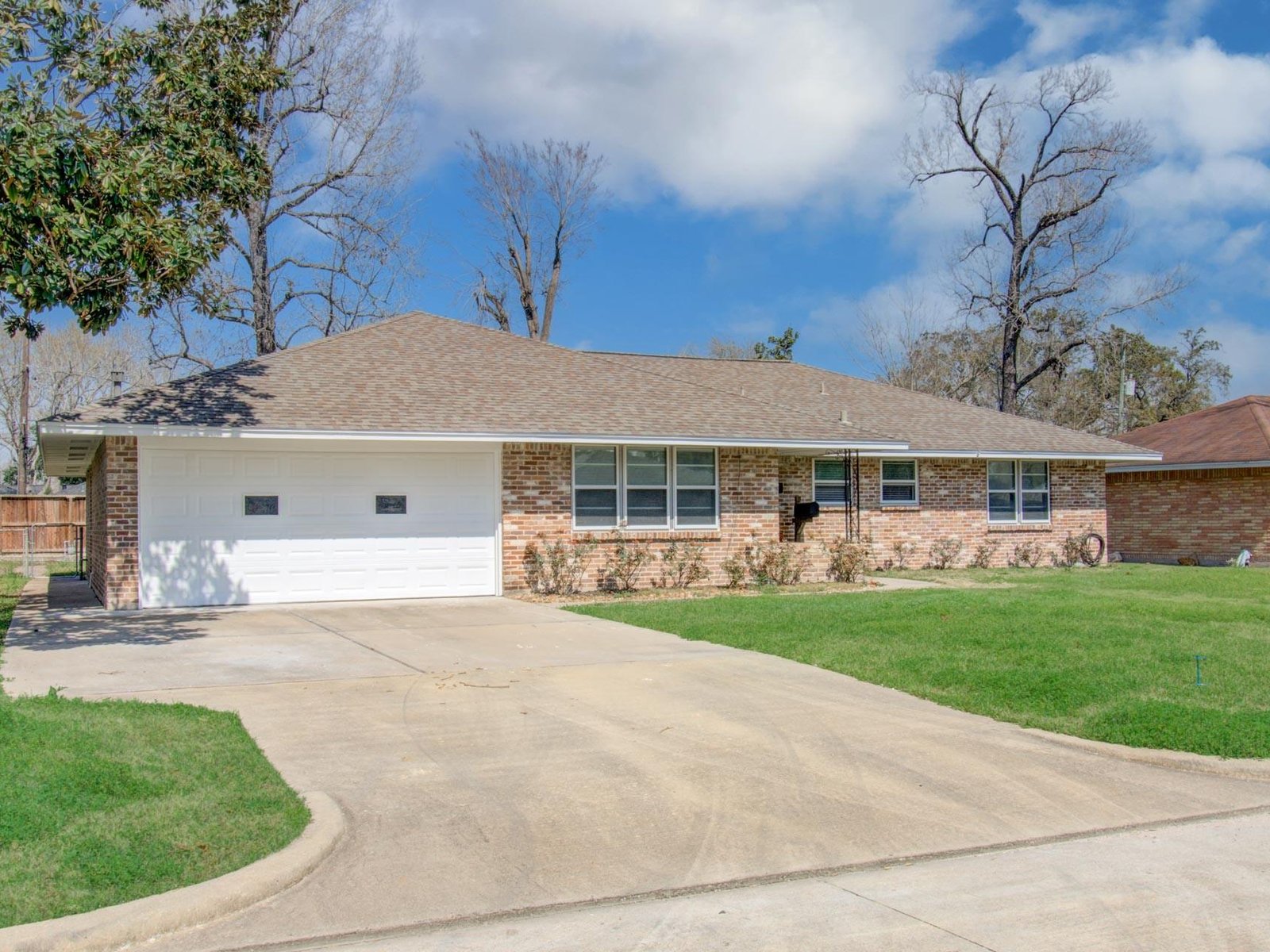 Front view of brick ranch home bought for cash in Outpost Estates, Houston TX