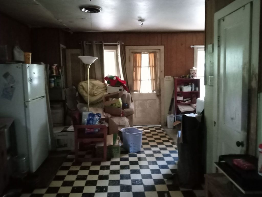 Kitchen and utility area in a distressed home purchased for cash in Cleveland, TX