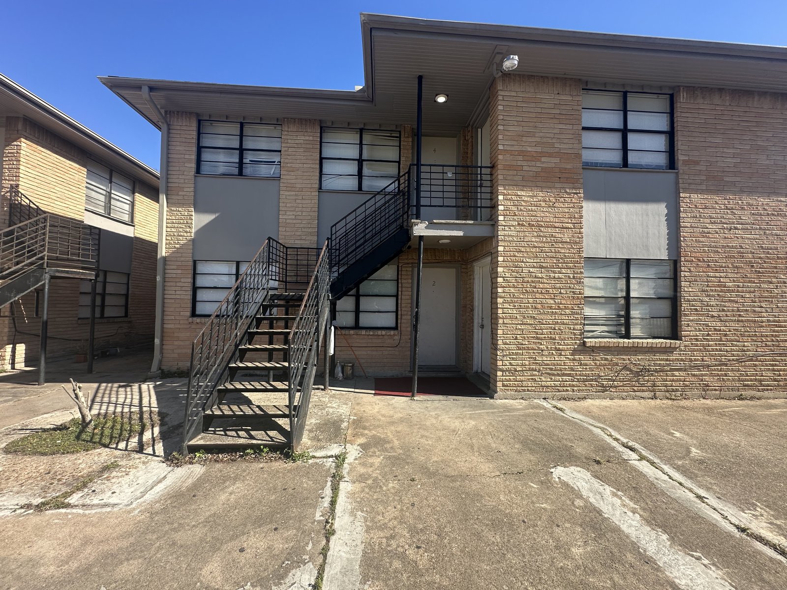 Front entrance and stairwell of an 8-unit rental building in Kashmere Gardens, Houston TX bought for cash