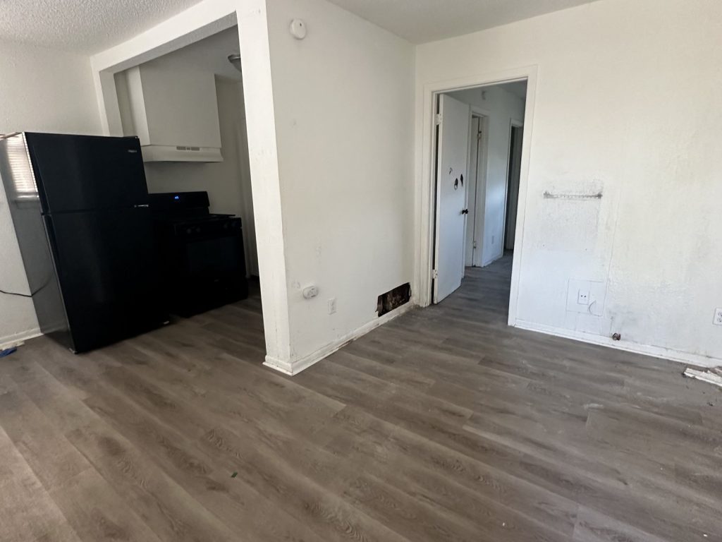 Vacant unit kitchen inside a foreclosure-bound rental property in Kashmere Gardens, Houston