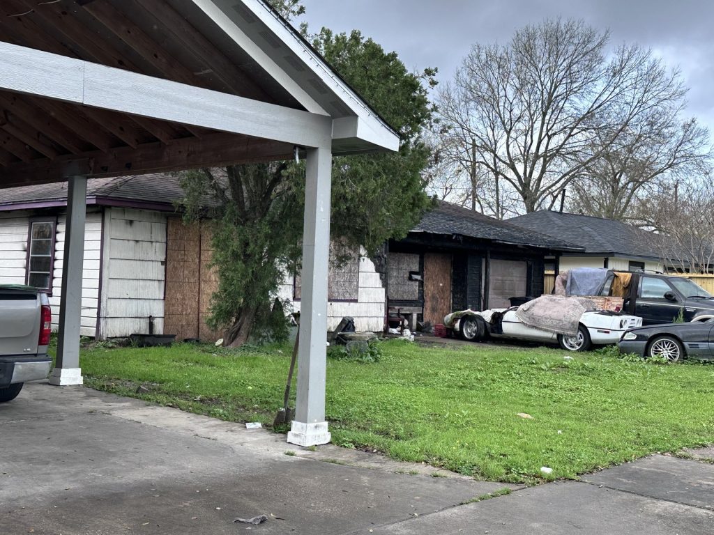 Boarded windows on fire-damaged Edgewood Houston TX home sold as-is for cash