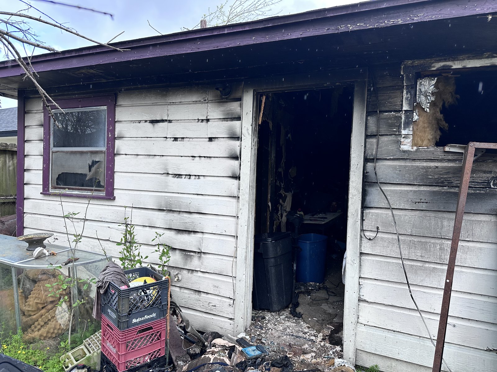 Fire-damaged exterior of abandoned home bought for cash in Edgewood, Houston TX